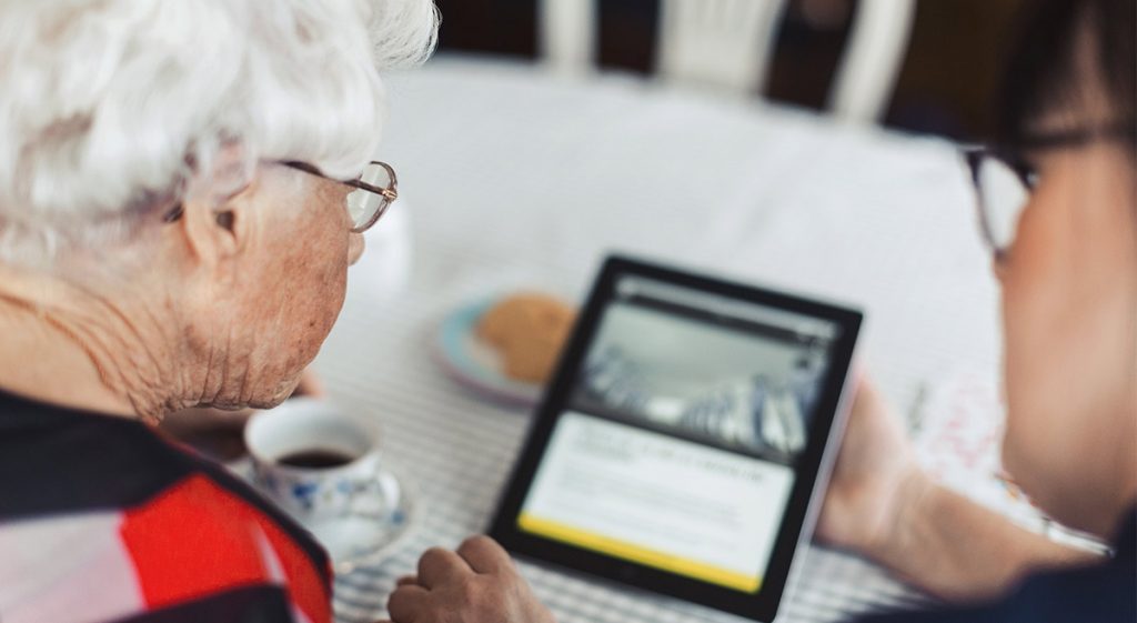 elderly woman using aged care tech